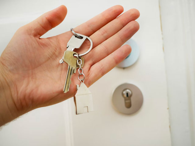Person holding keys to a new home